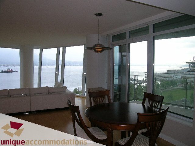 Dining area with wooden table, large windows, city view, hardwood floors. - 502 - 1233 W. Cordova Street, Vancouver Downtown