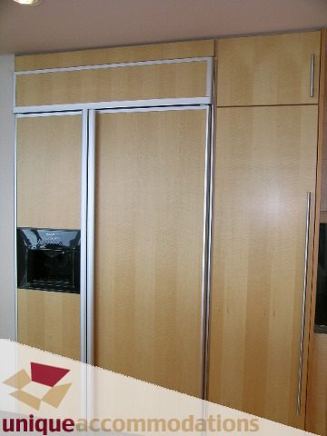 Furnished bedroom with sliding closet doors and wooden paneling. - 502 - 1233 W. Cordova Street, Vancouver Downtown