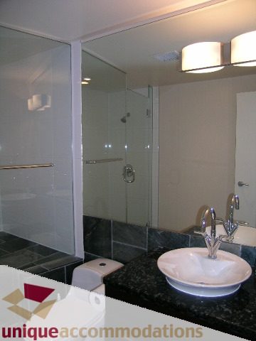 Furnished bathroom with modern sink and glass shower, black countertops. - 502 - 1233 W. Cordova Street, Vancouver Downtown