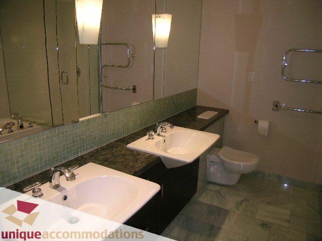 Bathroom with granite countertops, modern fixtures, and a large mirror. - 502 - 1233 W. Cordova Street, Vancouver Downtown