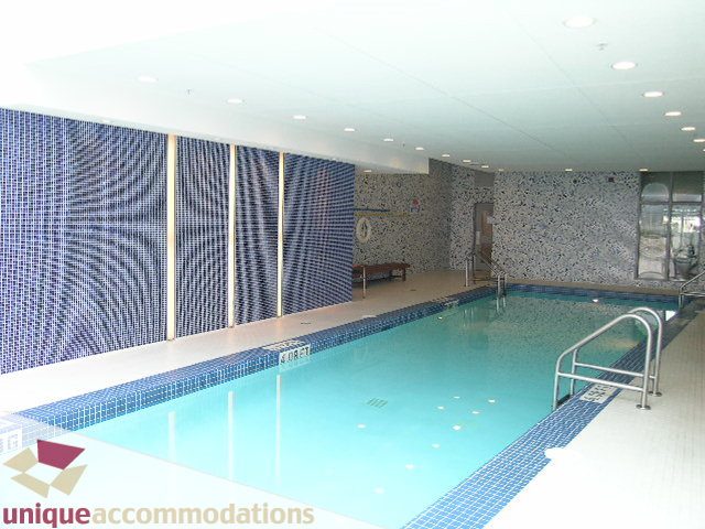 Spacious living room with large windows, modern decor, and a cozy fireplace. - 502 - 1233 W. Cordova Street, Vancouver Downtown