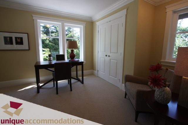 Furnished dining area with large windows, natural light, and a cozy ambiance. - 1287 Sinclair Court, West Vancouver