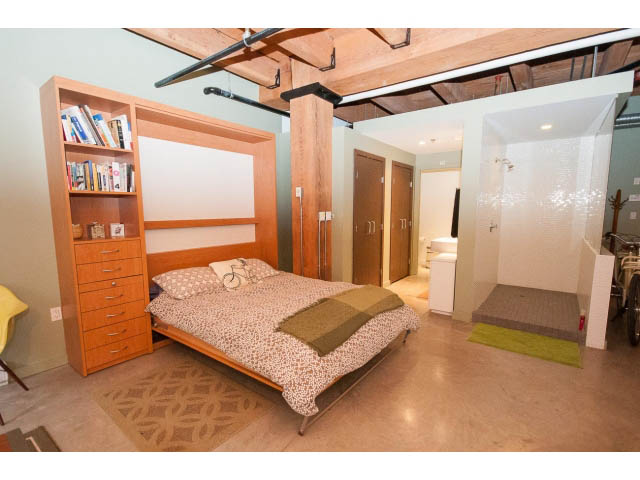 Bright loft with Murphy bed, bookshelf, and modern decor. - 210 - 55 E Cordova St, Vancouver Downtown
