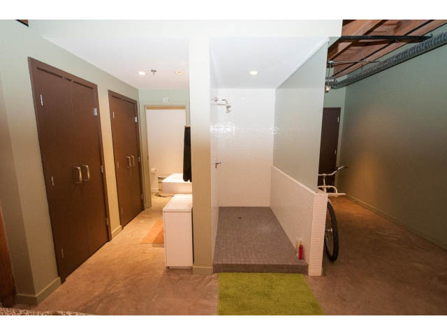 Furnished loft with modern decor, green rug, and white walls. - 210 - 55 E Cordova St, Vancouver Downtown