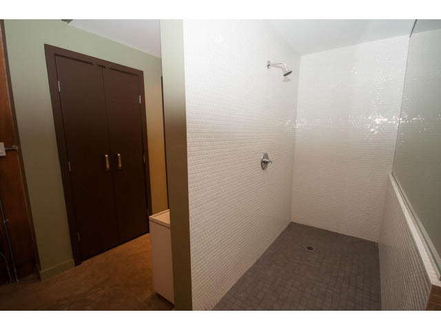 Furnished bathroom with white mosaic tiles and a shower head. - 210 - 55 E Cordova St, Vancouver Downtown