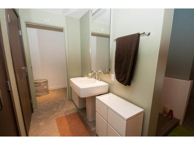 Bright bathroom with white countertop and brown towel. - 210 - 55 E Cordova St, Vancouver Downtown