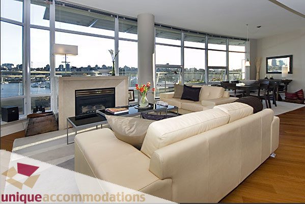 Spacious living room with large windows, city view, and modern furnishings. - 801- 628 Kinghorne Mews, Vancouver Downtown