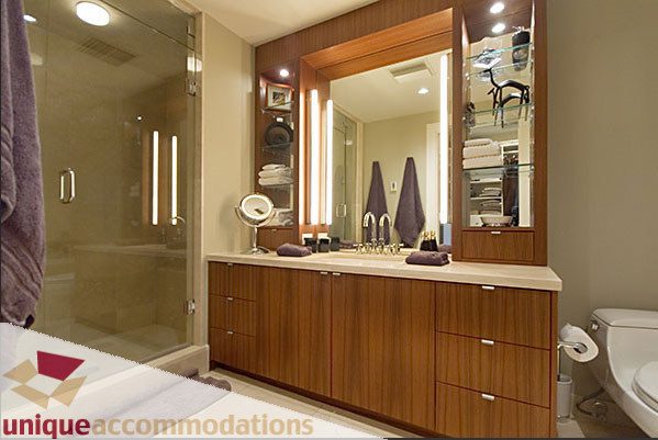 Spacious bathroom with wooden vanity, large mirror, and walk-in shower. - 801- 628 Kinghorne Mews, Vancouver Downtown
