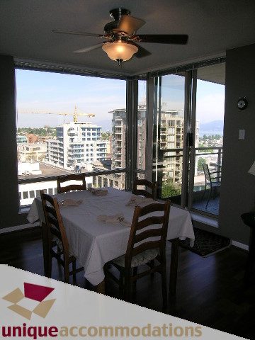 Furnished dining area with city view and hardwood floors. - 802-1590 West 8th Ave, Vancouver West Side