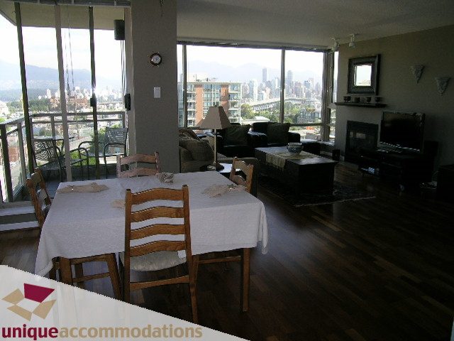 Furnished dining area with city view and hardwood floors. - 802-1590 West 8th Ave, Vancouver West Side