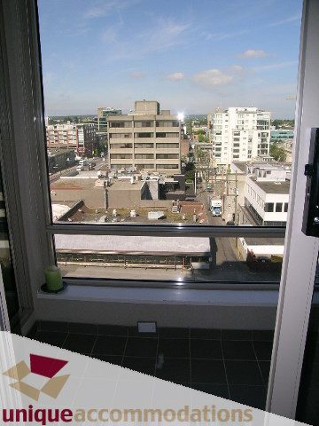 Bright living room with city view and modern furnishings. - 802-1590 West 8th Ave, Vancouver West Side
