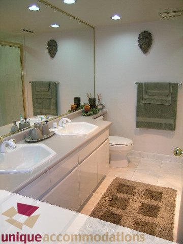 Furnished bathroom with modern fixtures, large mirror, and plush bath mat. - 802-1590 West 8th Ave, Vancouver West Side