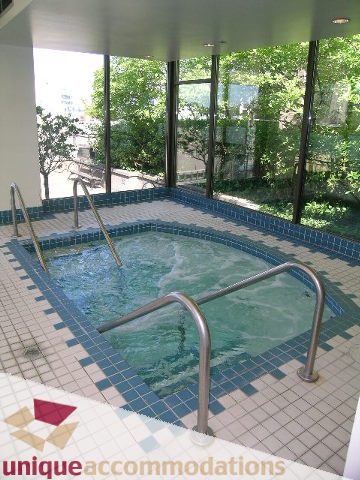 Spacious, sunlit hot tub with tiled surround and views of greenery. - 802-1590 West 8th Ave, Vancouver West Side