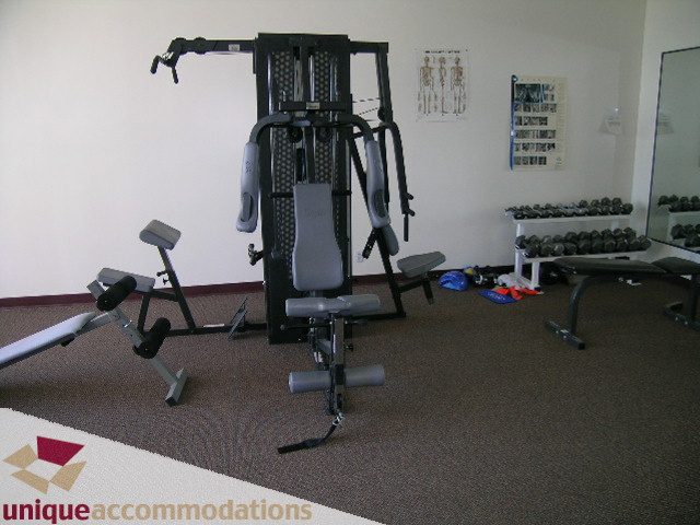 Fitness room with exercise equipment and mirrors. - 802-1590 West 8th Ave, Vancouver West Side