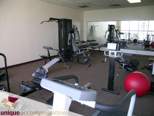 Fitness room with cardio and weight machines, spacious layout. - 802-1590 West 8th Ave, Vancouver West Side