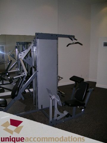 Fitness room with weight machines and mirrors. - 184 Chesterfield Avenue, North Vancouver