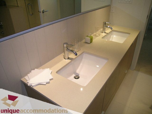 Furnished bathroom with dual sinks and modern faucet, clean and bright. - 184 Chesterfield Avenue, North Vancouver