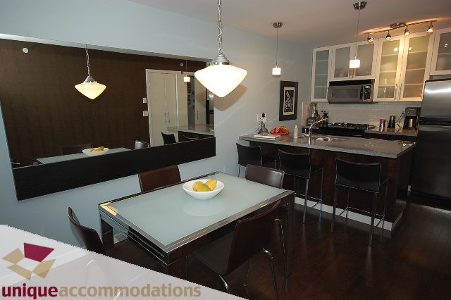Bright kitchen with modern island, dark hardwood floors, and pendant lighting. - 1229 Richards Street, Vancouver Downtown