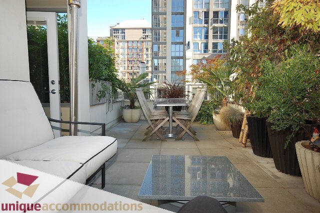 Furnished patio with outdoor furniture, plants, and city view. - 1229 Richards Street, Vancouver Downtown