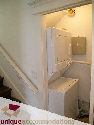 Bright laundry room with white washer and dryer, countertop above. - 1815 Creelman Avenue, Vancouver West Side