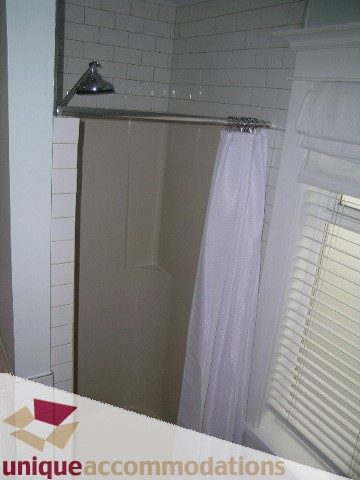 Bathroom with white subway tiles and sheer white curtains. - 1815 Creelman Avenue, Vancouver West Side
