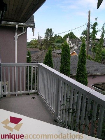 Balcony view of trees and rooftops, showcasing the townhouse's outdoor space. - 1815 Creelman Avenue, Vancouver West Side