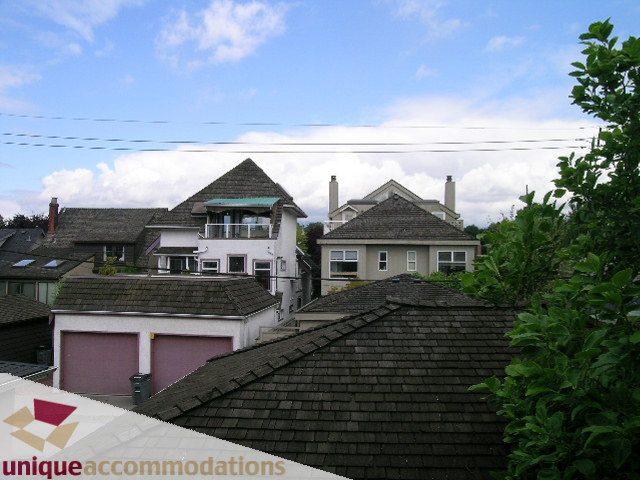 Furnished 4-bedroom townhouse with a city view and shingled rooftops. - 1815 Creelman Avenue, Vancouver West Side
