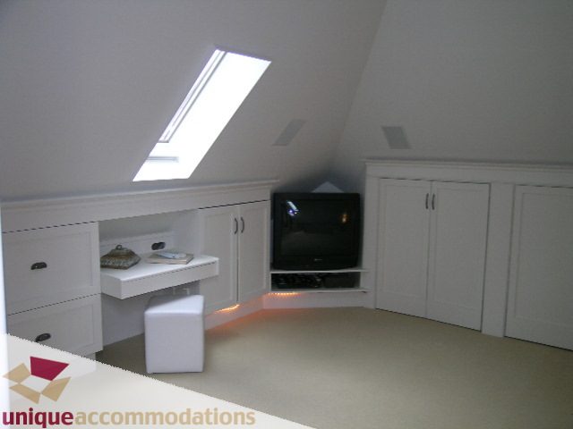 Bright attic bedroom with white cabinetry and a skylight. - 1815 Creelman Avenue, Vancouver West Side