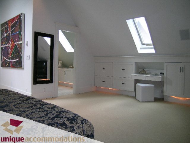 Bright bedroom with skylights and built-in storage, modern decor. - 1815 Creelman Avenue, Vancouver West Side