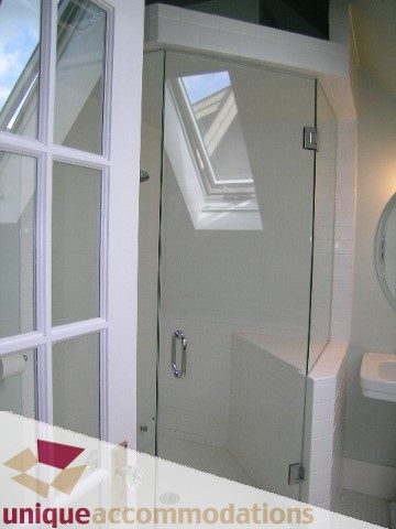 Bright bathroom with glass shower and skylight, modern design. - 1815 Creelman Avenue, Vancouver West Side