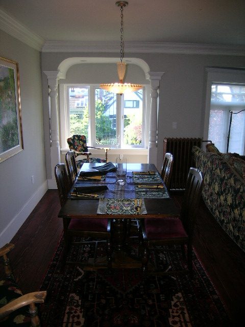 Spacious dining area with wooden table, patterned chairs, and large windows, perfect for gatherings. - 1963 McNicoll, Vancouver West Side