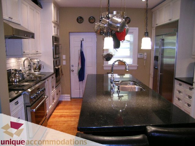 Bright kitchen with granite countertops, hardwood floors, and stainless steel appliances. - 995 Bute Street "Rand House", Vancouver Downtown