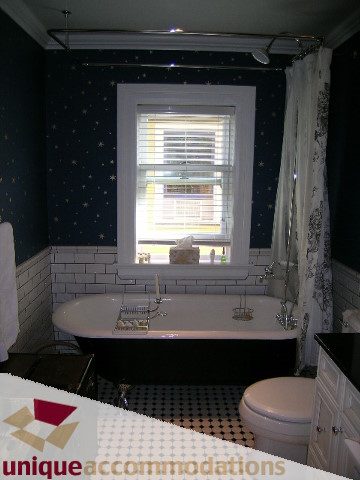 Bathroom with starry wallpaper, white sink, and window view. - 995 Bute Street "Rand House", Vancouver Downtown