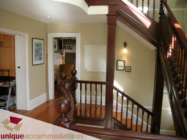 Furnished entryway with wooden staircase and hardwood floors. - 995 Bute Street "Rand House", Vancouver Downtown