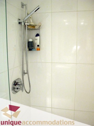 Bathroom with modern shower setup and white tiles. - 1019 - 788 Richards Street, Vancouver Downtown