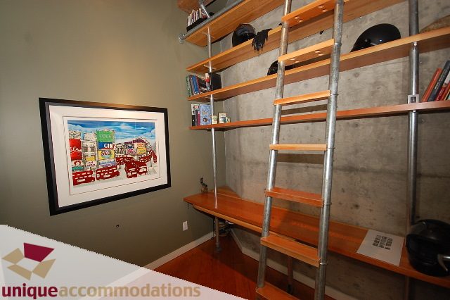 Bright living room with industrial shelving and framed art. - PH1-1178 Hamilton Street, Vancouver Downtown