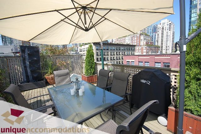 Furnished patio with outdoor seating, city view, and umbrella shade. - PH1-1178 Hamilton Street, Vancouver Downtown
