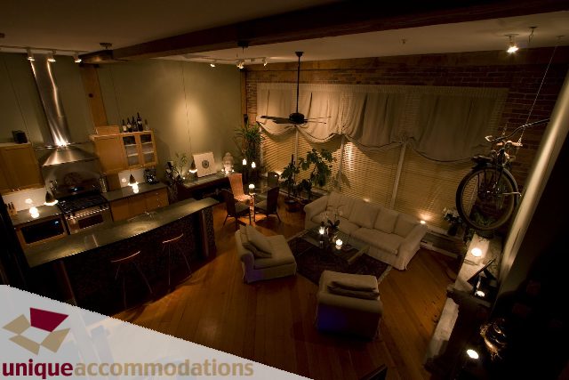 Furnished living room with hardwood floors, modern kitchen, and city view. - PH1-1178 Hamilton Street, Vancouver Downtown
