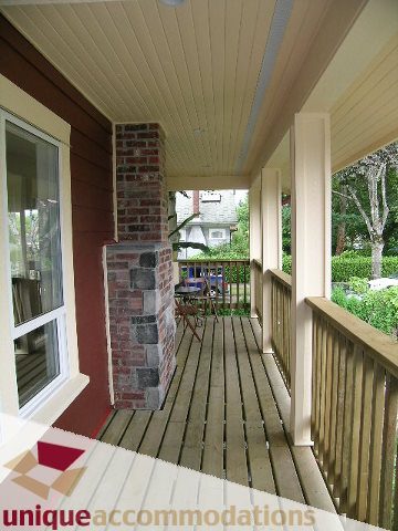 Furnished porch with wooden deck and brick columns, perfect for relaxing. - 2915 Waterloo Street, Vancouver West Side