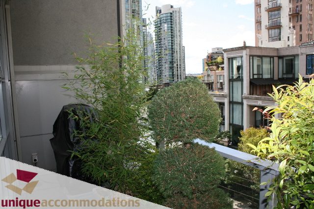 Furnished balcony with city view and lush greenery. - 605 - 1228 Homer Street, Vancouver Downtown