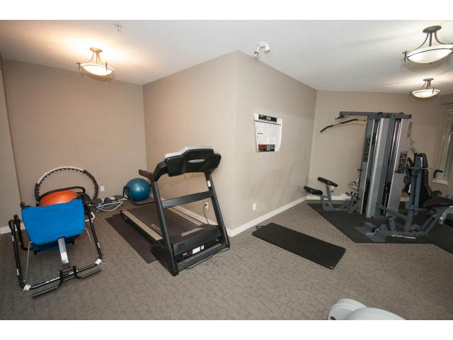 Furnished fitness room with cardio equipment and weights. - 418 - 1633 Mackay Avenue, North Vancouver