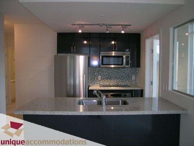 Bright kitchen with granite countertops and stainless steel appliances. - 1101 - 1188 West Pender, Vancouver Downtown