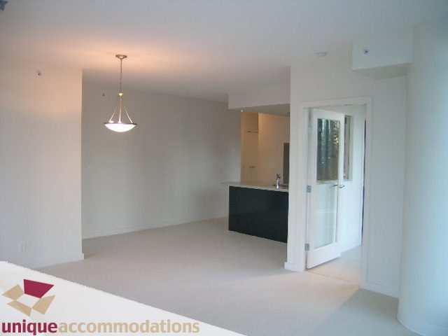 Bright living room with modern pendant light and city view. - 1101 - 1188 West Pender, Vancouver Downtown