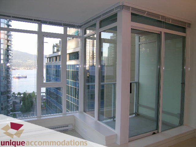 Bright living room with large windows, city view, and modern furnishings. - 1101 - 1188 West Pender, Vancouver Downtown