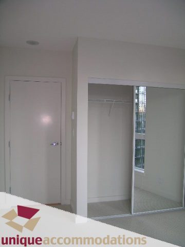 Bright and spacious bedroom with large sliding closet doors and city view. - 1101 - 1188 West Pender, Vancouver Downtown
