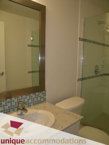 Bathroom with granite countertop and glass shower, modern design. - 1101 - 1188 West Pender, Vancouver Downtown