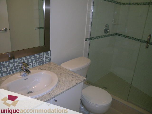 Furnished bathroom with granite countertops and a shower/tub combo. - 1101 - 1188 West Pender, Vancouver Downtown