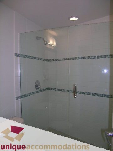 Furnished bathroom with glass shower and white tiles. - 1101 - 1188 West Pender, Vancouver Downtown