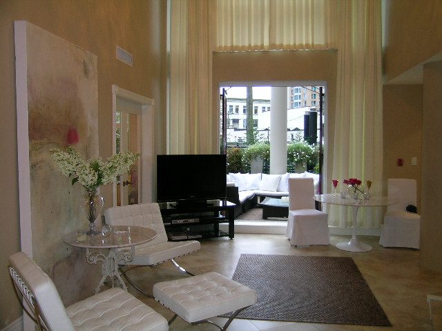 Bright living room with modern furniture, city view, and large windows. - 202 -1280 Richards Street, Vancouver Downtown