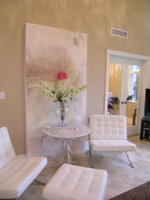 Bright living room with white furniture, abstract art, and large mirror. - 202 -1280 Richards Street, Vancouver Downtown